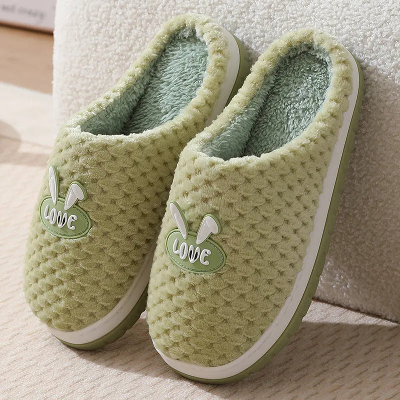 Rabbit plaid design women's house slippers in artificial fur with a flat heel and rubber sole.