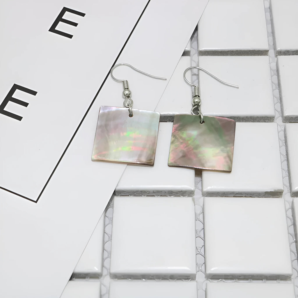 A pair of women's geometric earrings made from natural shell in a retro style.