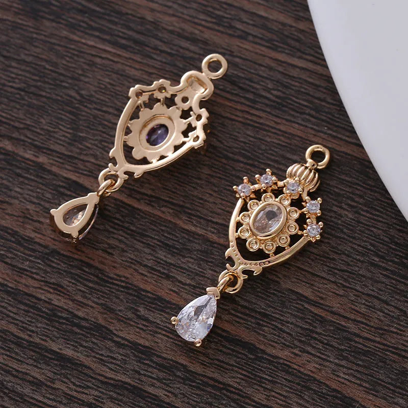 Small hollow water drop-shaped pendant with crown design and micro zircon details in various colours.