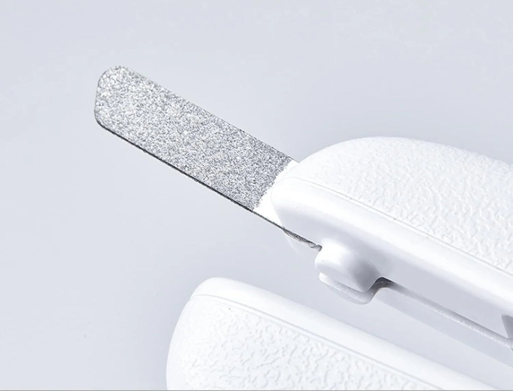 White pet nail clippers with LED light, transparent anti-splash baffle, and triangular steel blades for cats and dogs