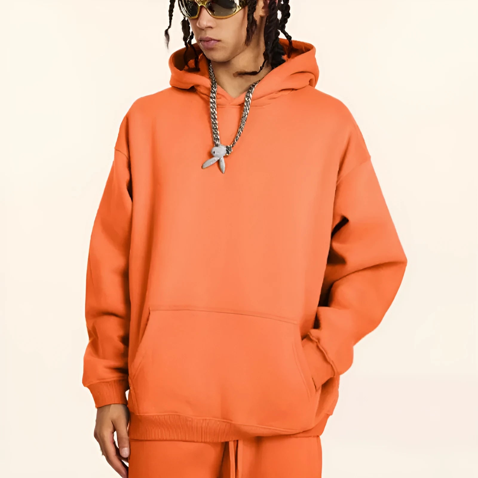 Man wearing a loose-fit cotton terry hooded sweater with drop-shoulder sleeves in a solid colour.