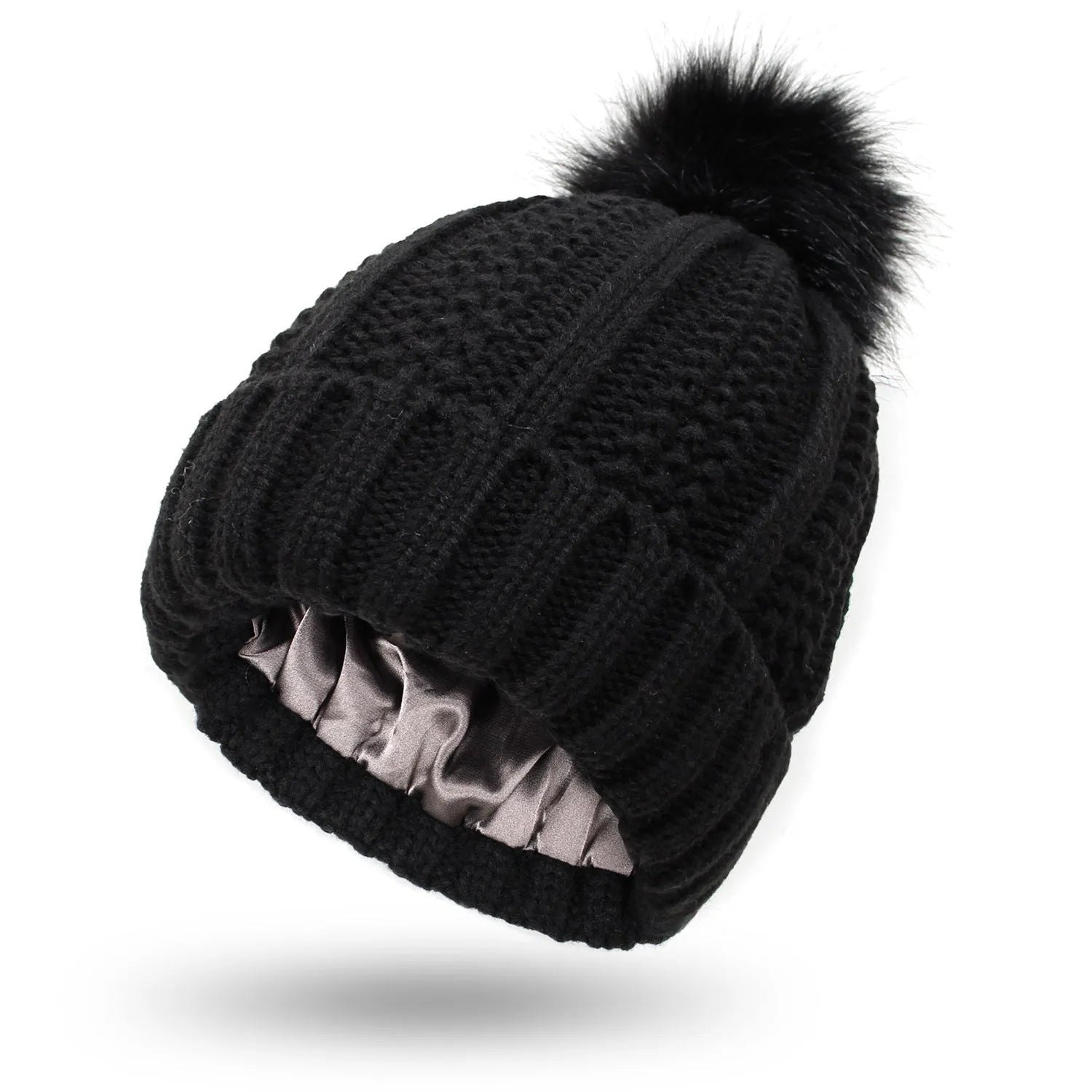 Woman wearing a light grey wool beanie with a faux fur pom pom and satin lining.
