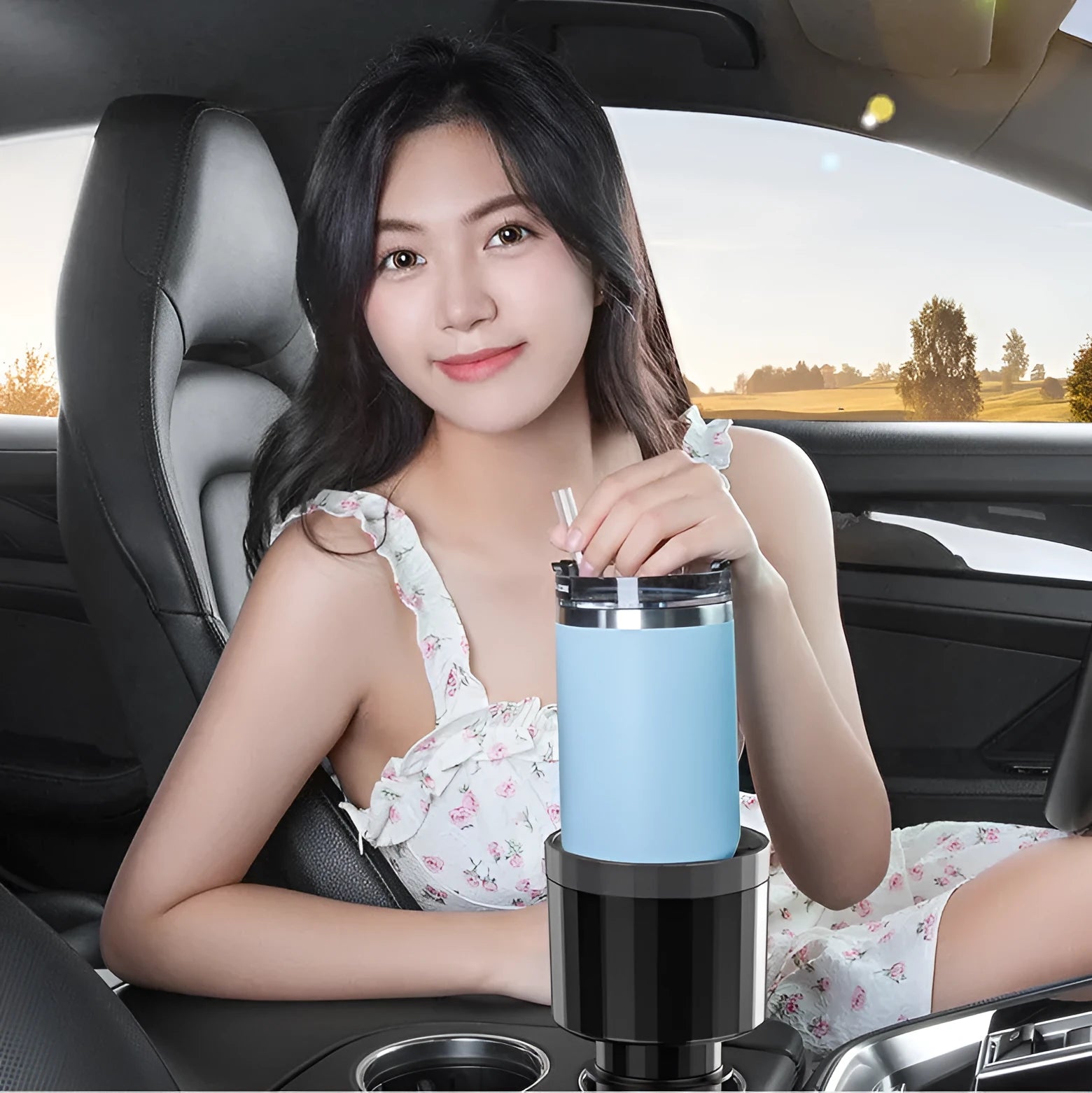 Matte black car cup holder expander with adjustable base for large bottles and travel mugs.