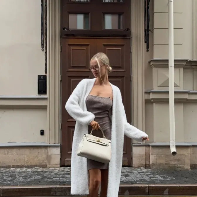 White longline knitted cardigan jacket with regular sleeves on a model.