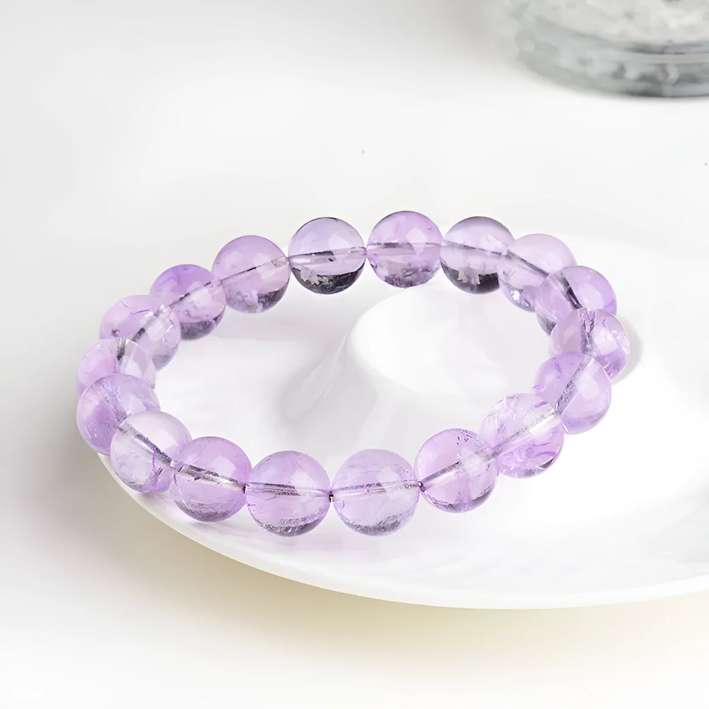 Lavender round amethyst bead bracelet with water ripple design on a cream body and transparent lavender beads.