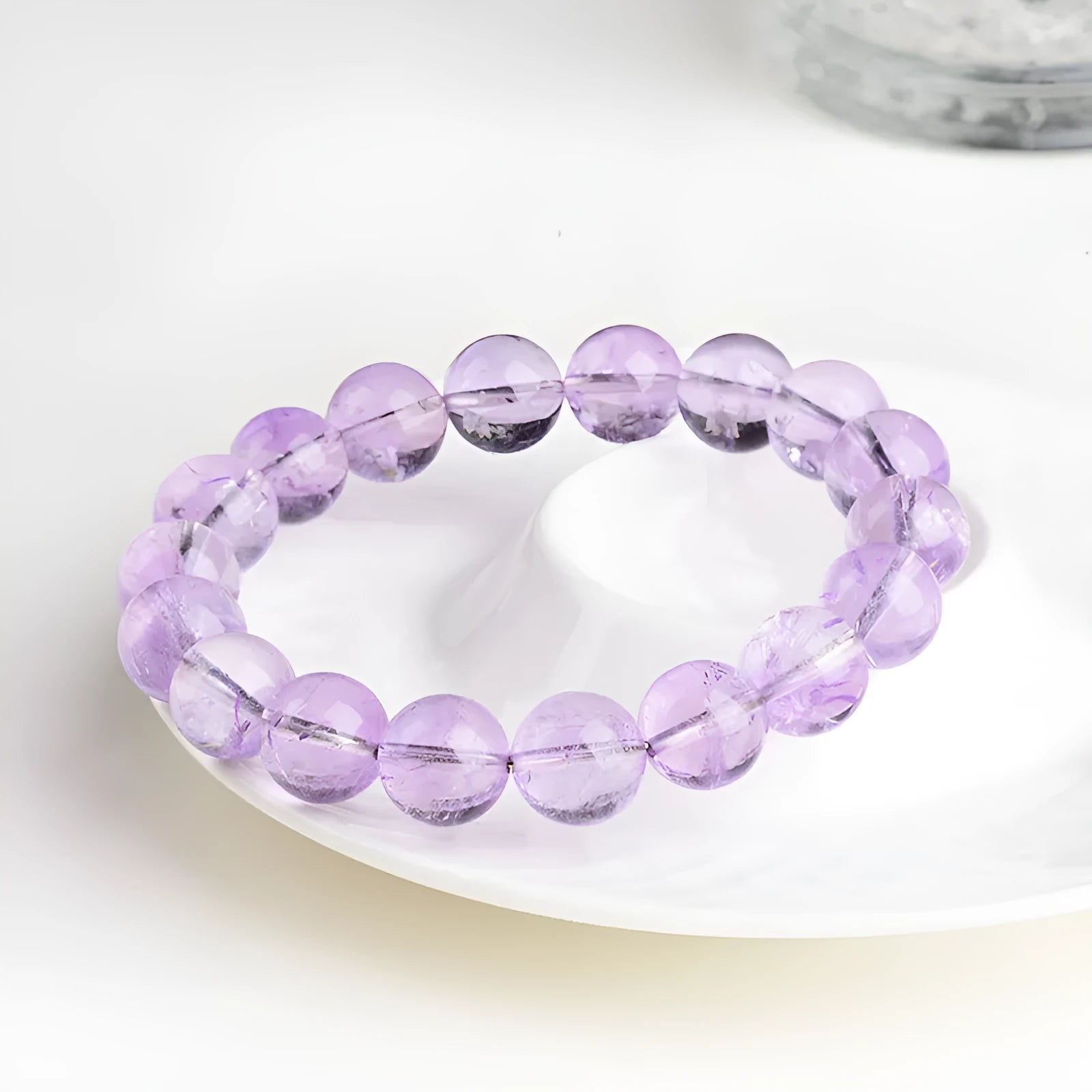 Lavender round amethyst bead bracelet with water ripple design on a cream body and transparent lavender beads.