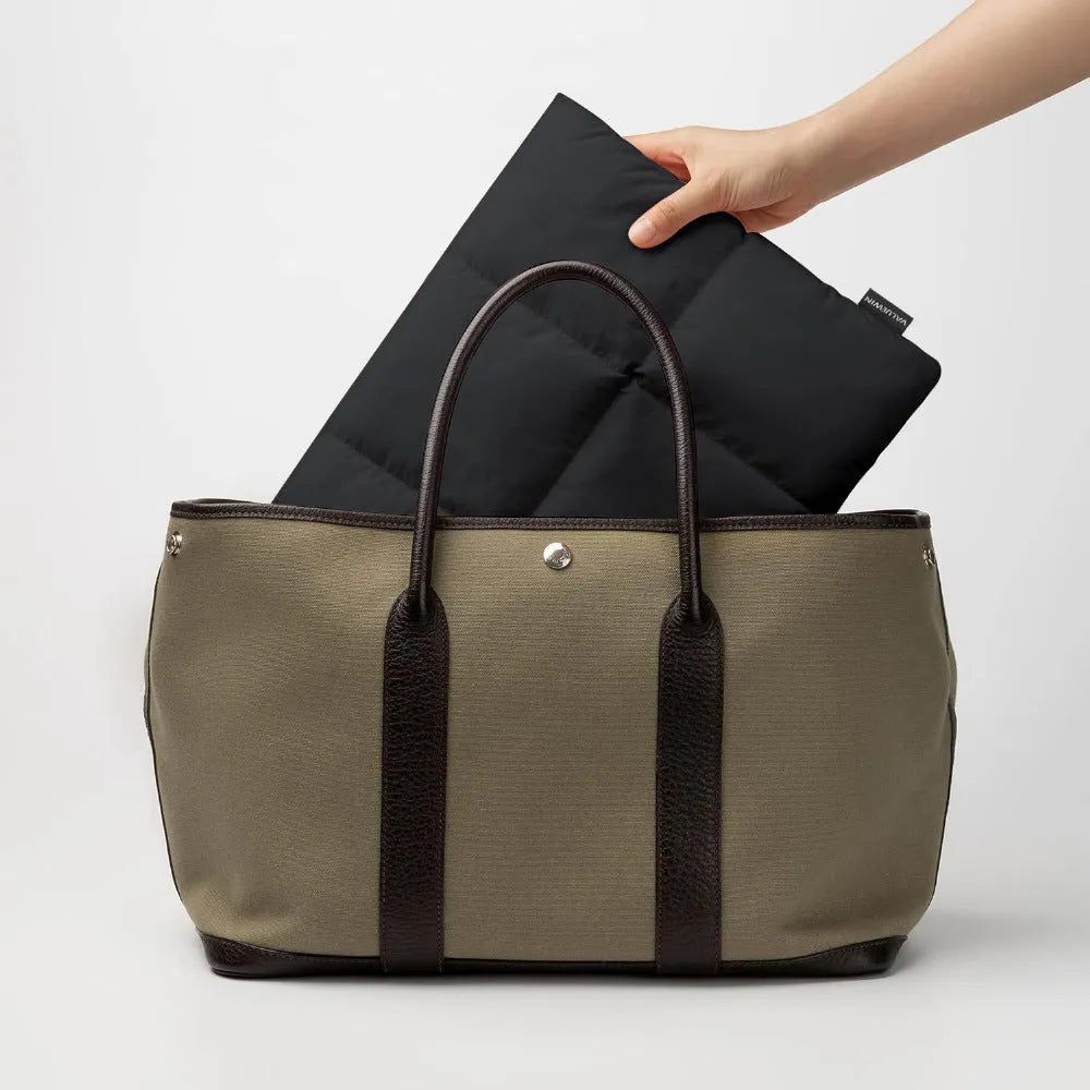 Black or khaki polyester laptop sleeve with fluffy lining for 13, 13.6, 15, or 15.6-inch laptops.