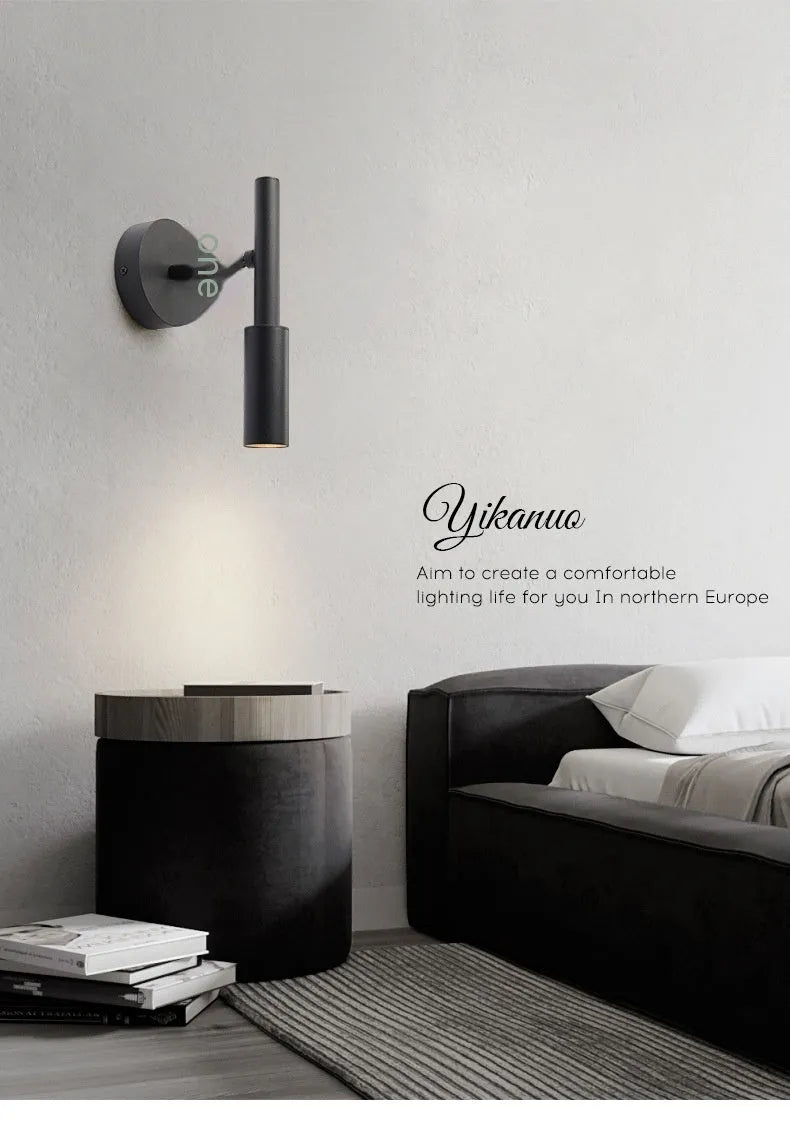 Modern wrought iron wall lamp in black or white, 100mm by 230mm, with three colour light options.