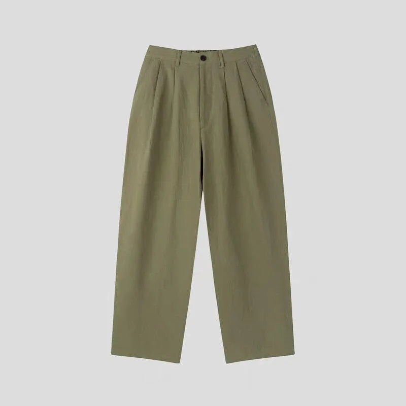 Men's lightweight apricot coloured wide-leg cotton linen trousers with a pencil leg opening on a hanger