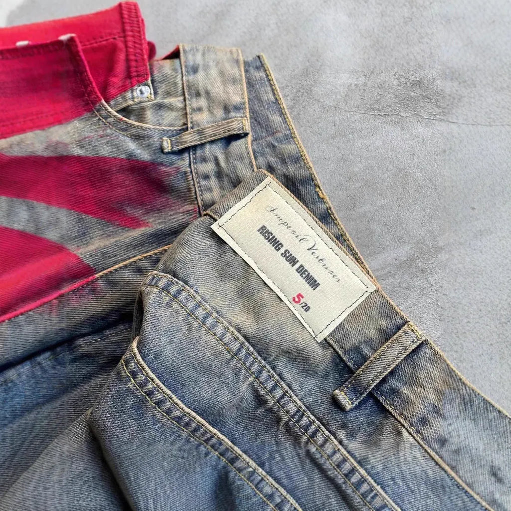 Men's wide-leg blue denim trousers with straight-leg cut and zipper fly, laid flat on a neutral background