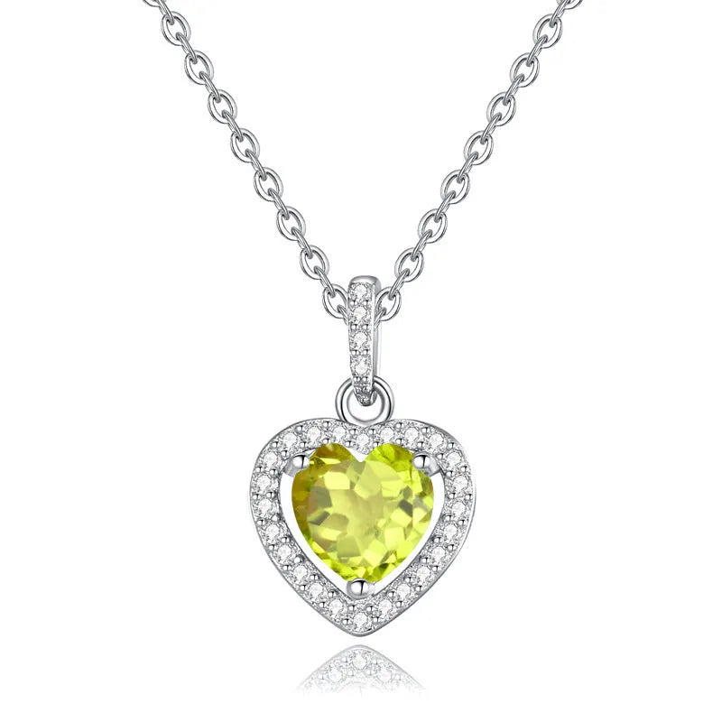 Women's sterling silver necklace with heart-shaped pendant containing natural gemstone on adjustable cross chain