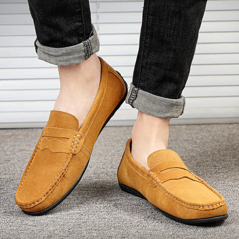 Men's solid colour suede leather slip-on loafers with a flat rubber sole.