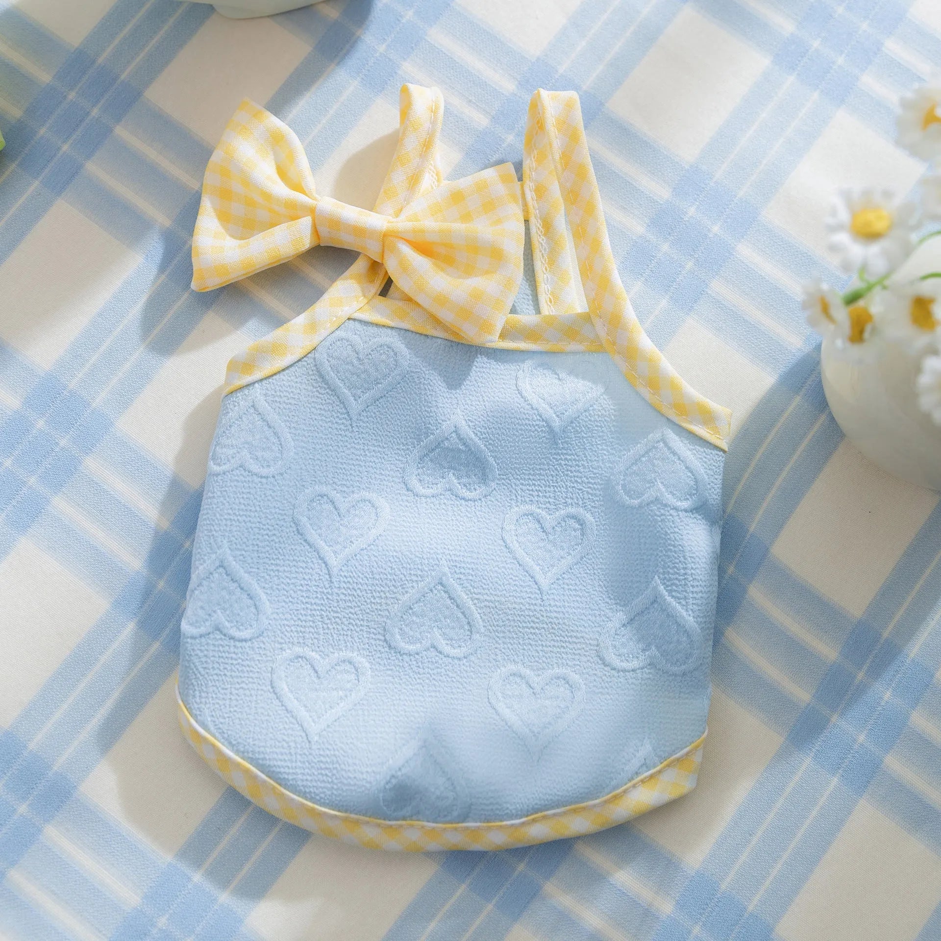 Small dog wearing heart relief texture bow suspenders vest in Bondi Blue colour