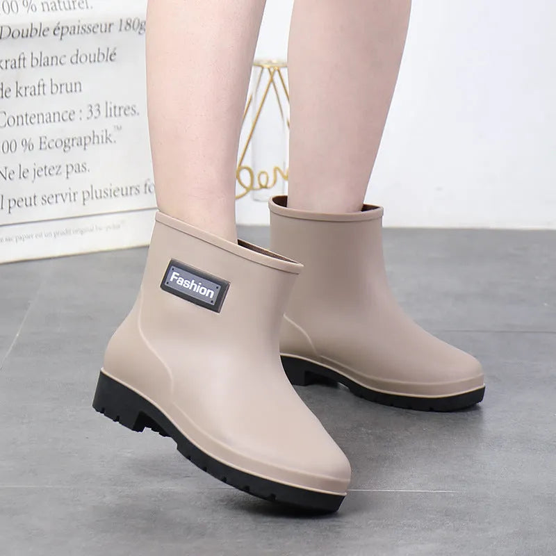 Women's mid-calf PVC rain boot in black, shown with a low heel and optional wool lining.