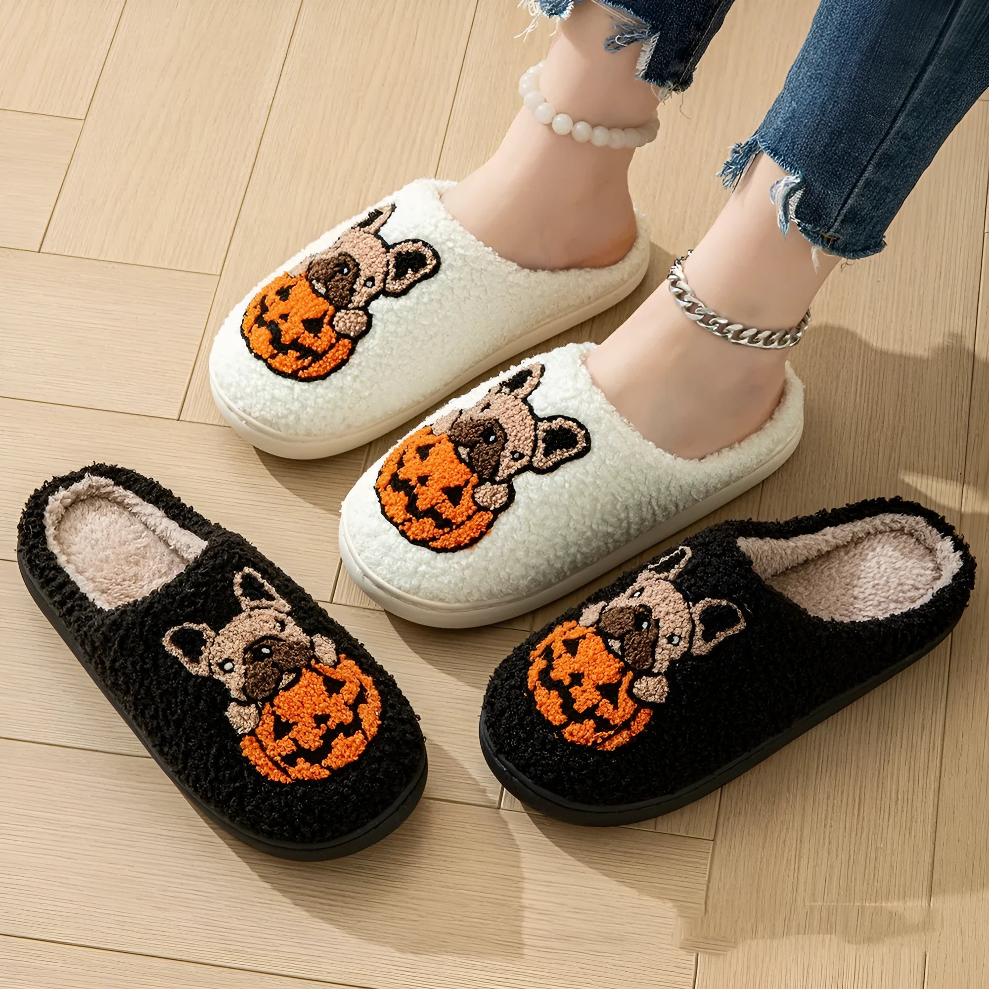 Black and white Halloween slippers with pumpkin patterns and plush fabric construction
