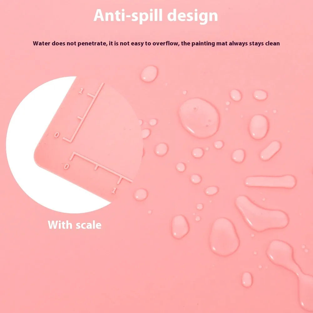 Green silicone painting mat measuring 50 by 40 centimetres with two round bowl wells for holding water or paint.