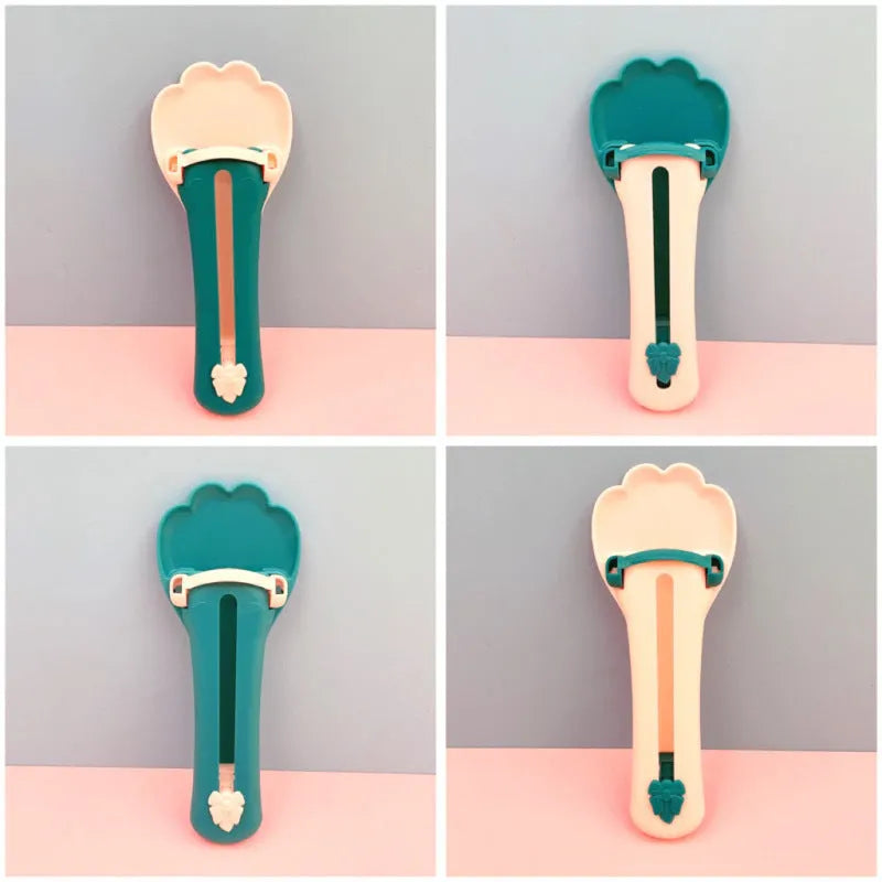 Green and pink plastic pet food scoop with squeeze mechanism for dispensing treats and liquid food