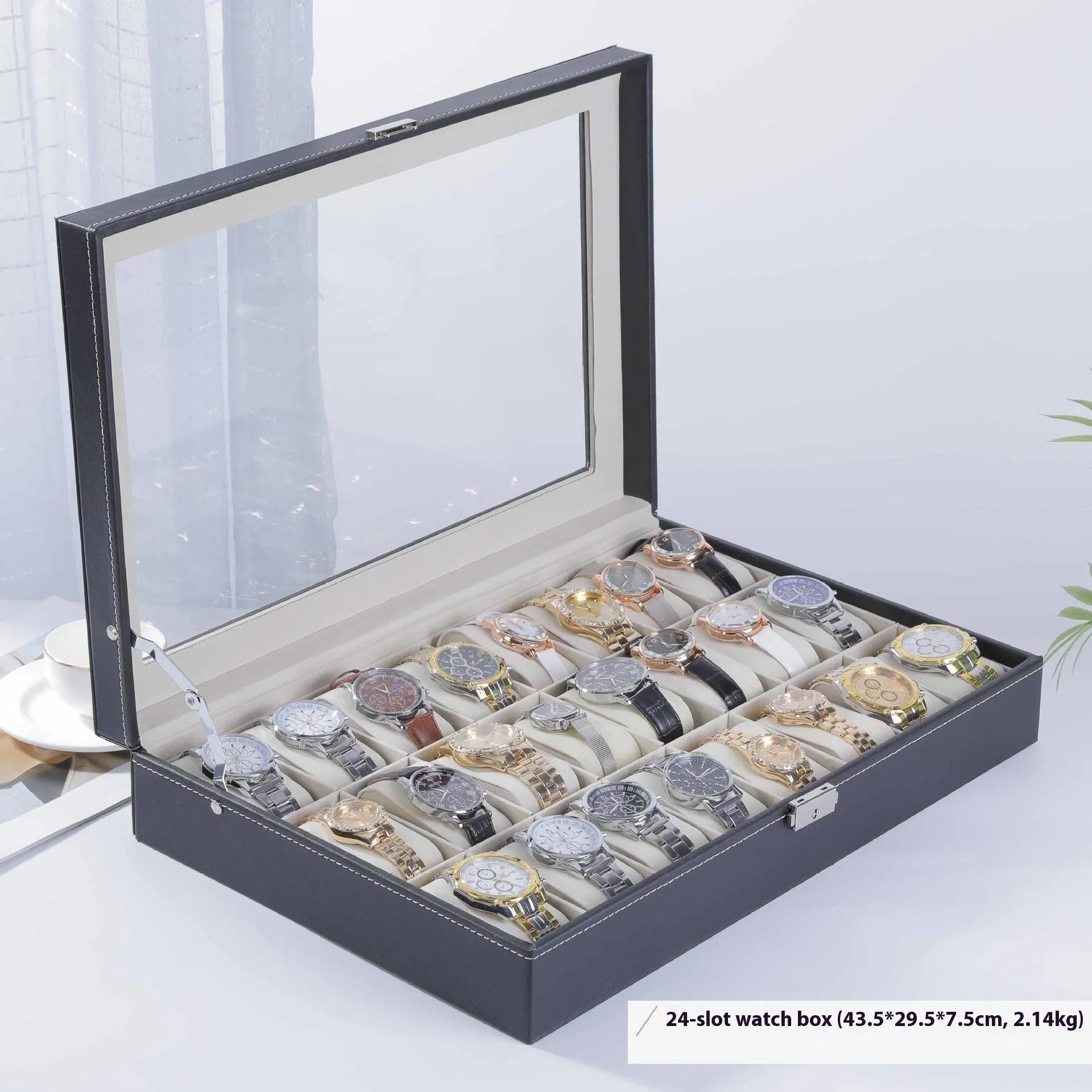 Grey leather watch storage box with clear lid showing watch compartments