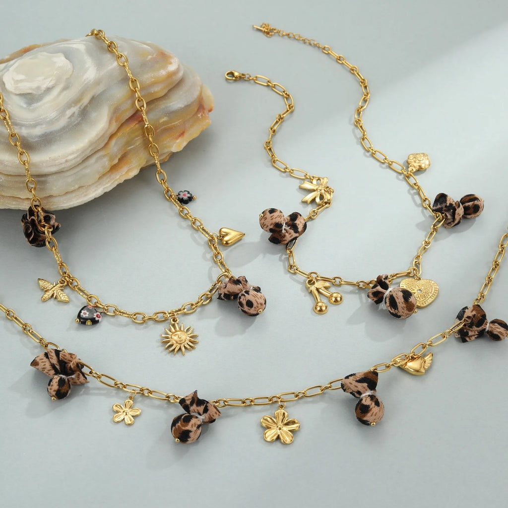 Leopard, love heart, and flowers design on a geometric stainless steel pendant necklace with an adjustable chain.