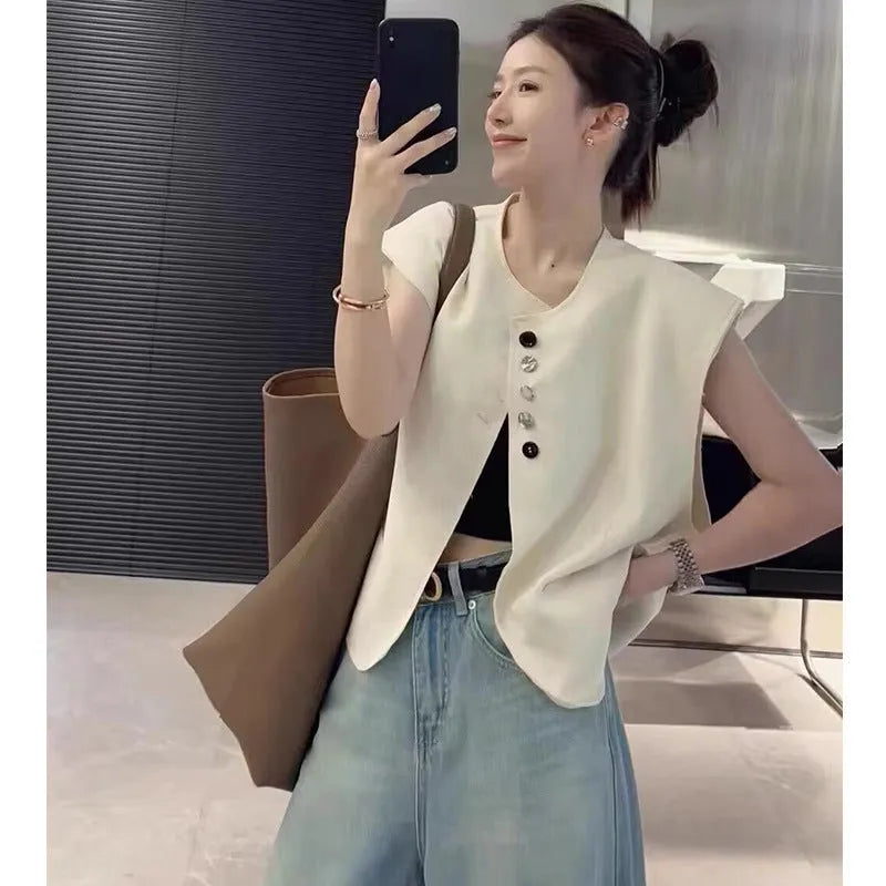 Women's loose fit polyester vest in milky white with pocket detail and 40cm length