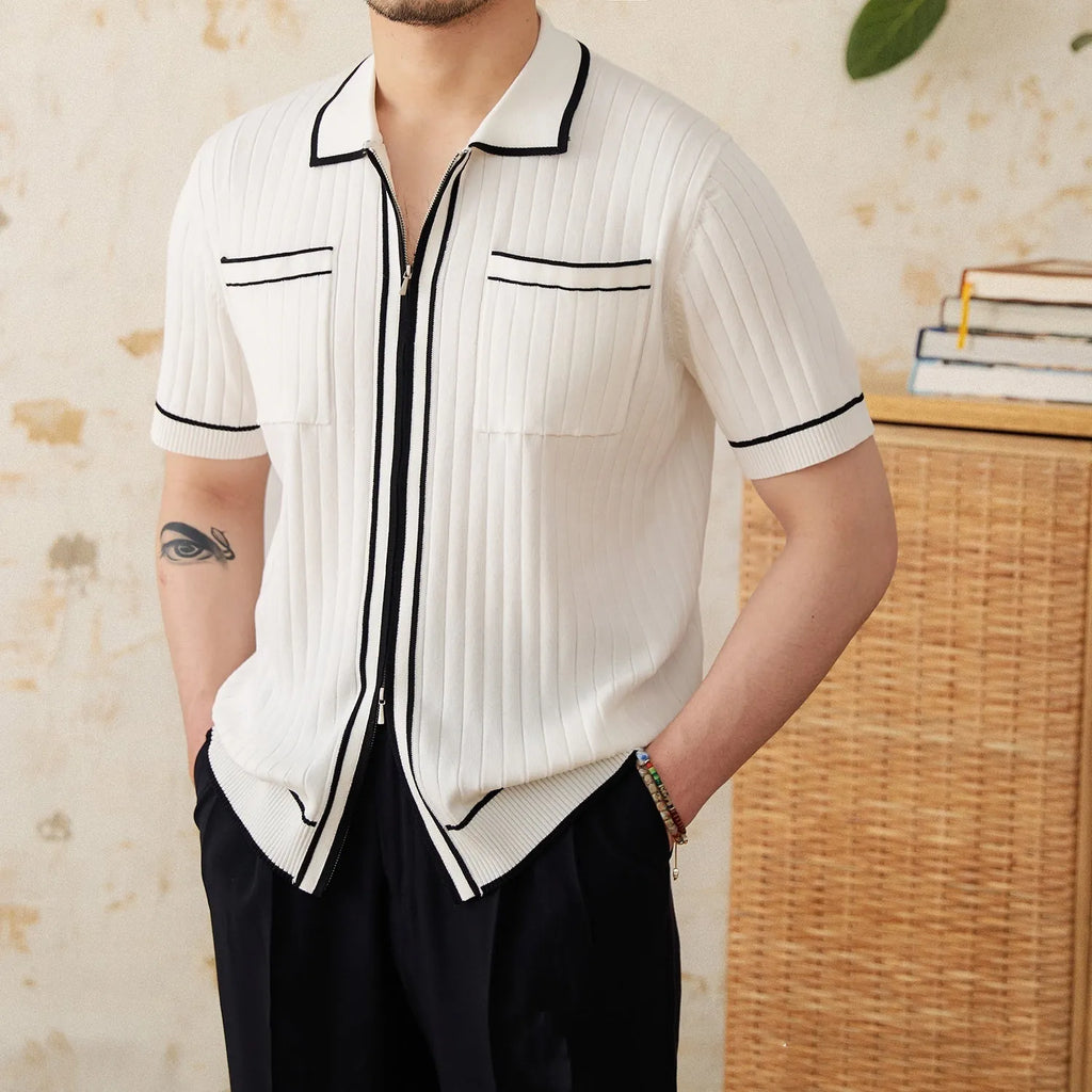 Man wearing a slim black polo shirt with a lapel collar and short sleeves.