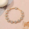 Electroplated zinc alloy bracelet with floral design in gold and silver colour variations