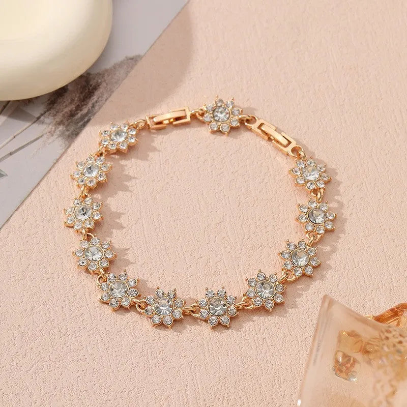 Electroplated zinc alloy bracelet with floral design in gold and silver colour variations