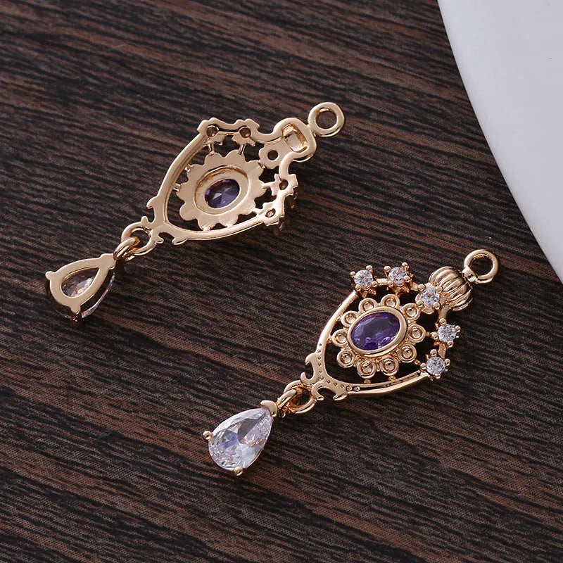 Small hollow water drop-shaped pendant with crown design and micro zircon details in various colours.
