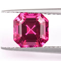 Cultivated pigeon blood red ruby gemstone in round cut on a white background.