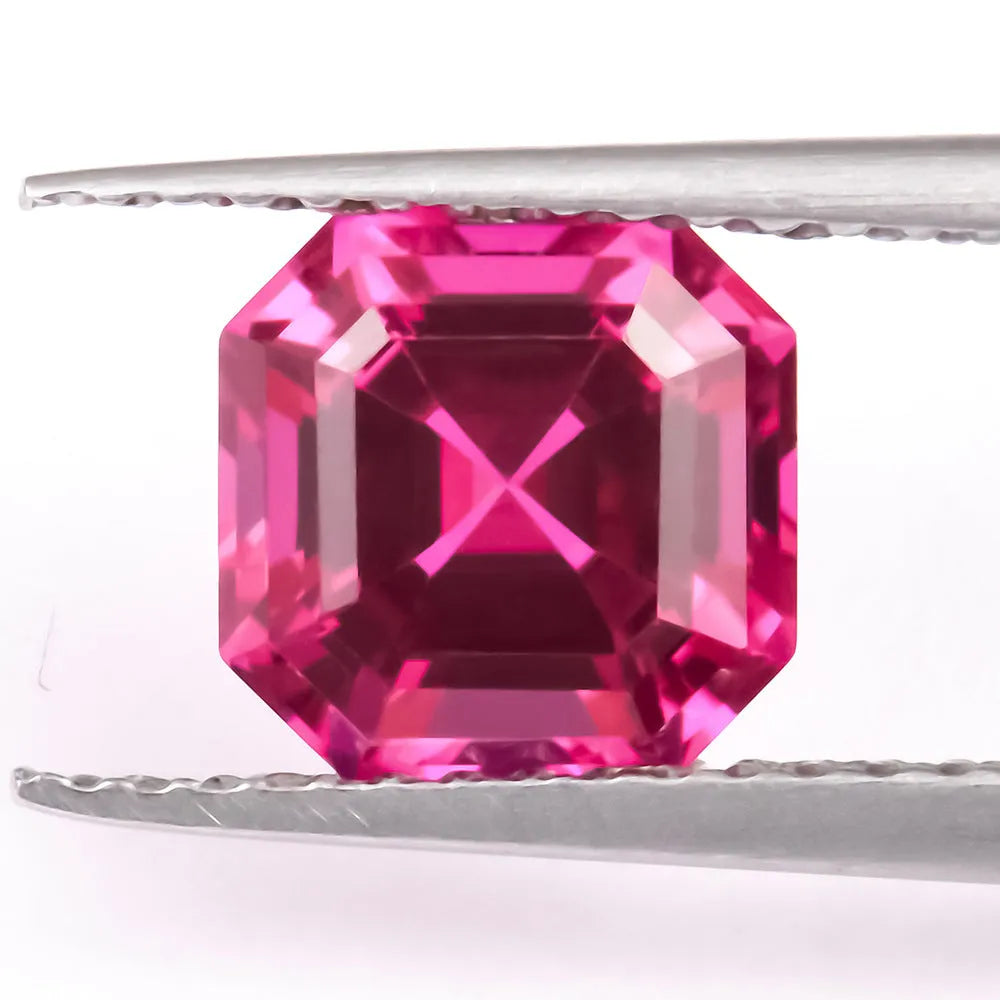 Cultivated pigeon blood red ruby gemstone in round cut on a white background.