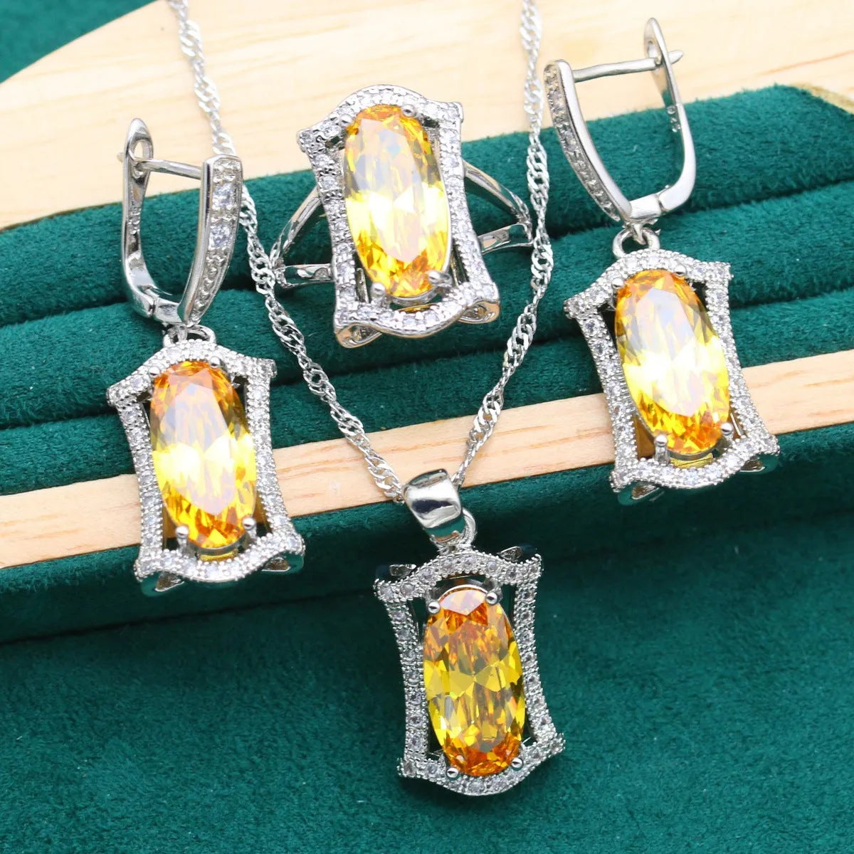 Yellow and olive anti-allergy alloy zircon jewellery set showing necklace, earrings, ring, and bracelet on a dark background.