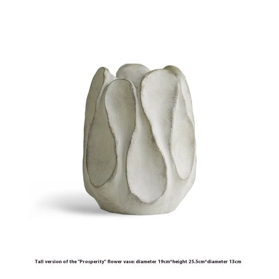 Handmade irregular shaped ceramic vase in natural glaze on a wooden surface.
