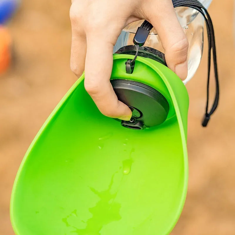 Blue portable pet water bottle with fold-out drinking bowl and carabiner clip for outdoor use