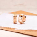 Rose gold women's earrings with three hollowed heart shapes in circular design