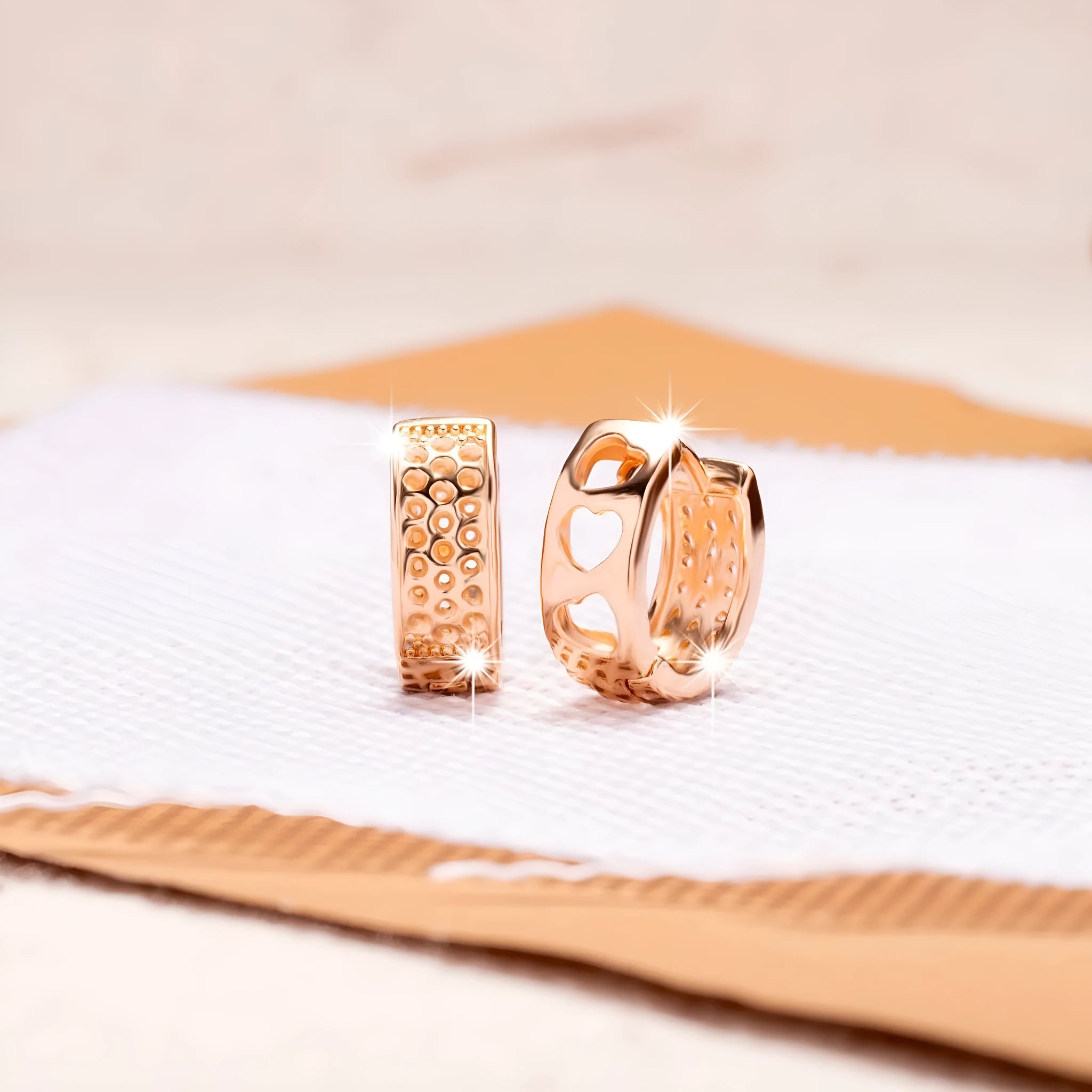 Rose gold women's earrings with three hollowed heart shapes in circular design