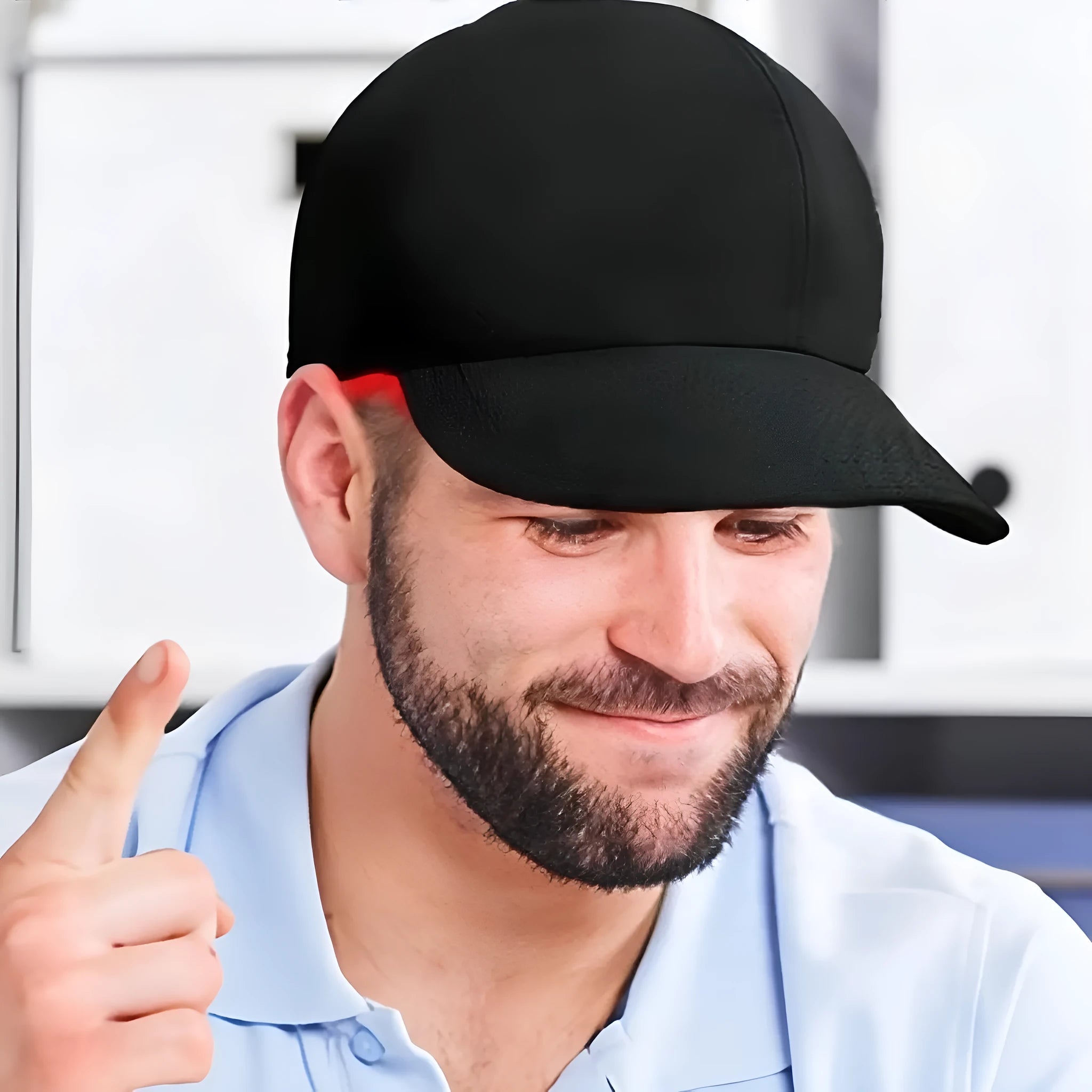 Black infrared peaked cap for hair growth with LED light strip and separate controller.