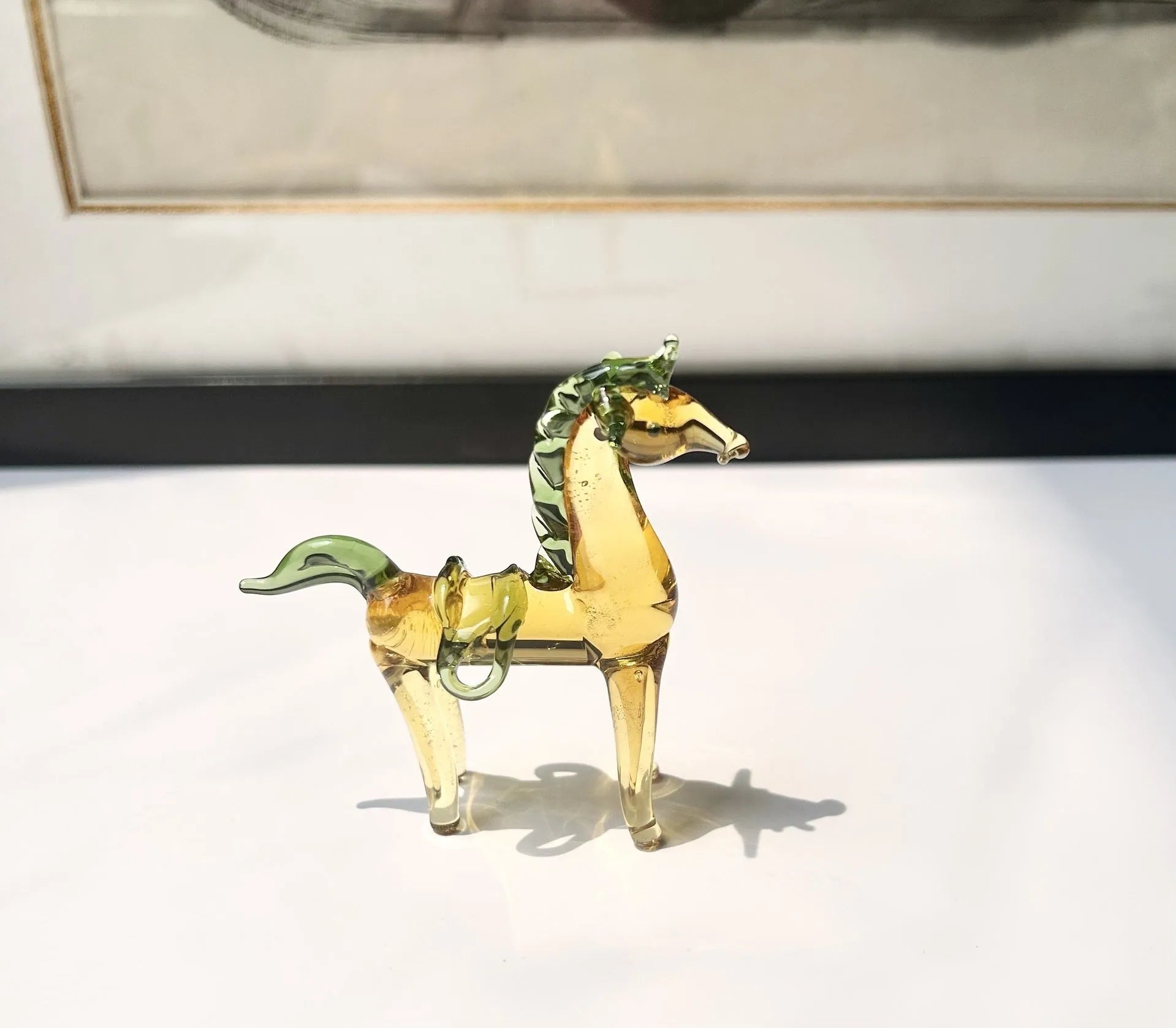 Coloured glaze horse sculpture in brown finish on wooden desk