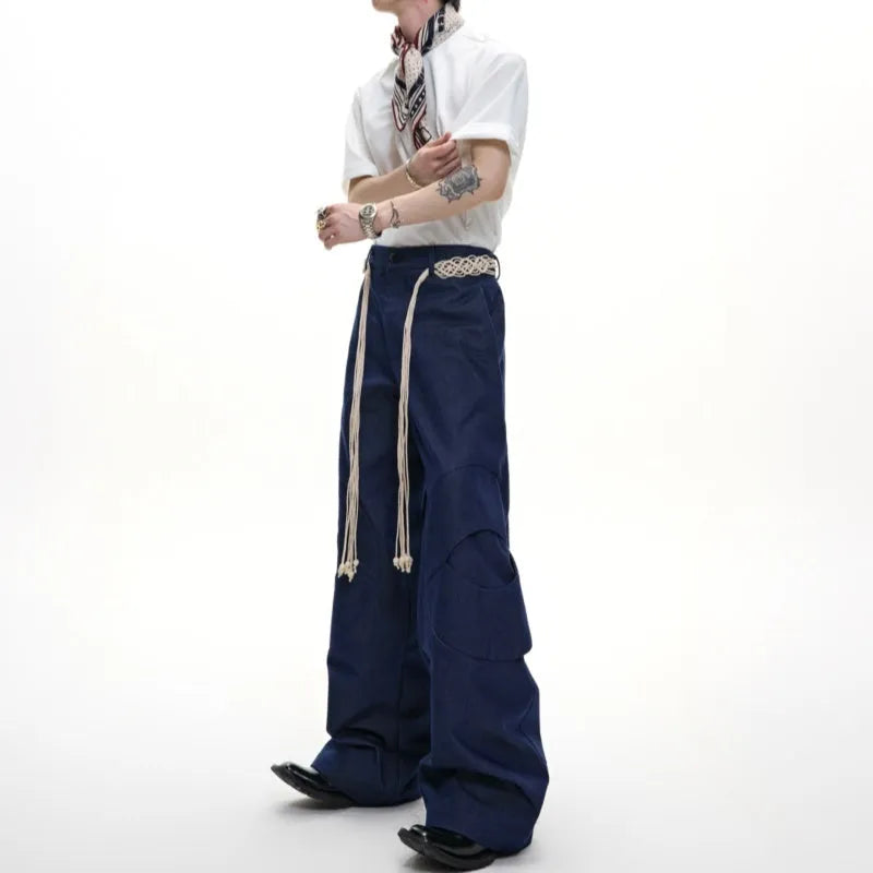 Men's dark blue cotton straight-leg jeans with loose fit, showing 3D cutting and belt stitching detail.