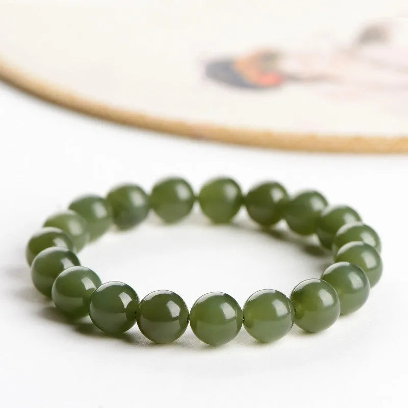 Polished Hetian jade beaded bracelet in ice-like clear water colour on a wrist.