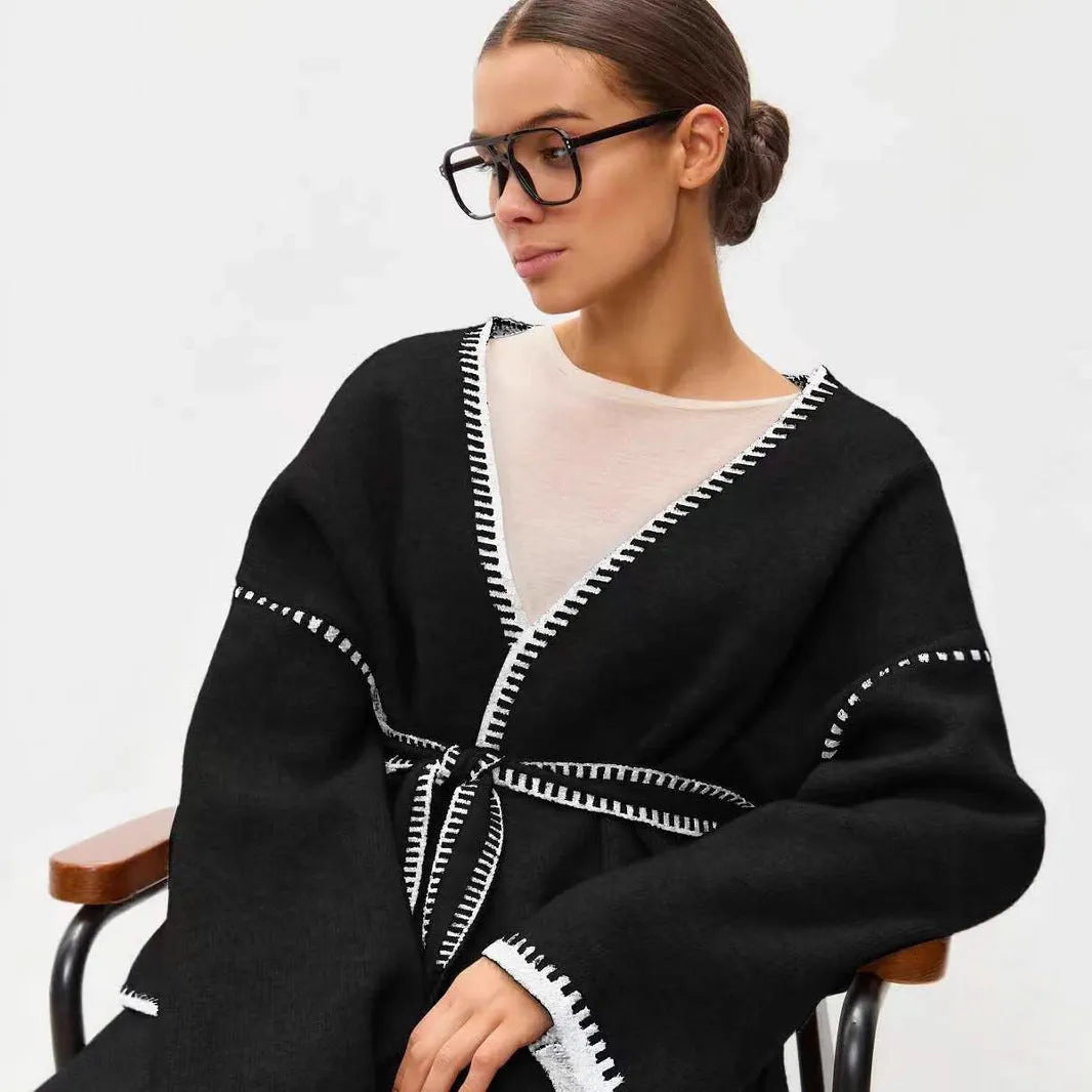 Lace-up front knitted cardigan in camel colour showing loose mid-length design and long sleeves