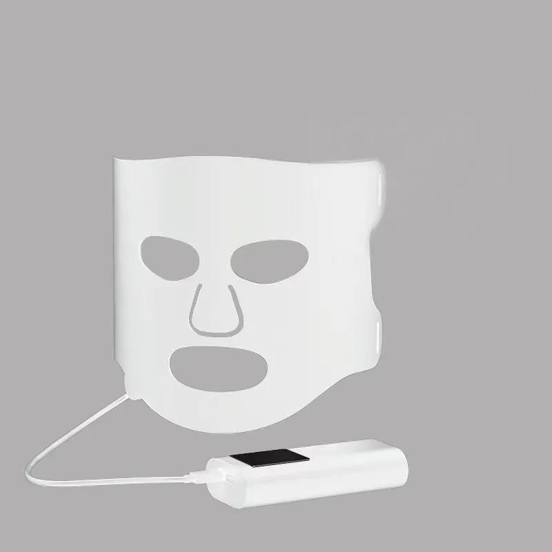 Black and white LED phototherapy face mask with controller showing seven colour light modes