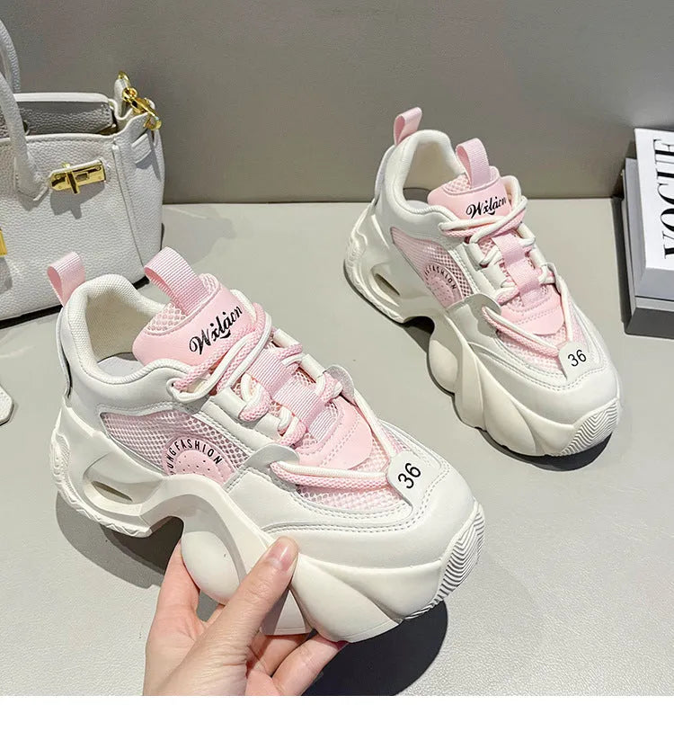Women's beige platform sneakers with a cross-strap design and thick sole.