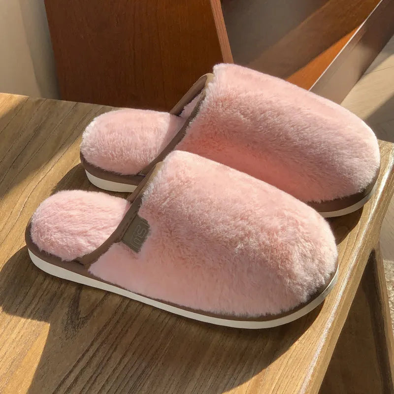 Solid colour PVC winter plush house slippers with car stitching detail on a non-slip sole.