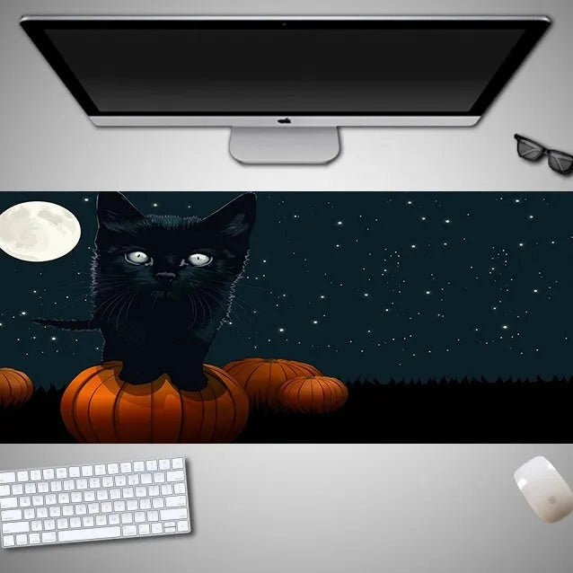 Large Halloween-themed computer mouse pad with graphic design on a desk