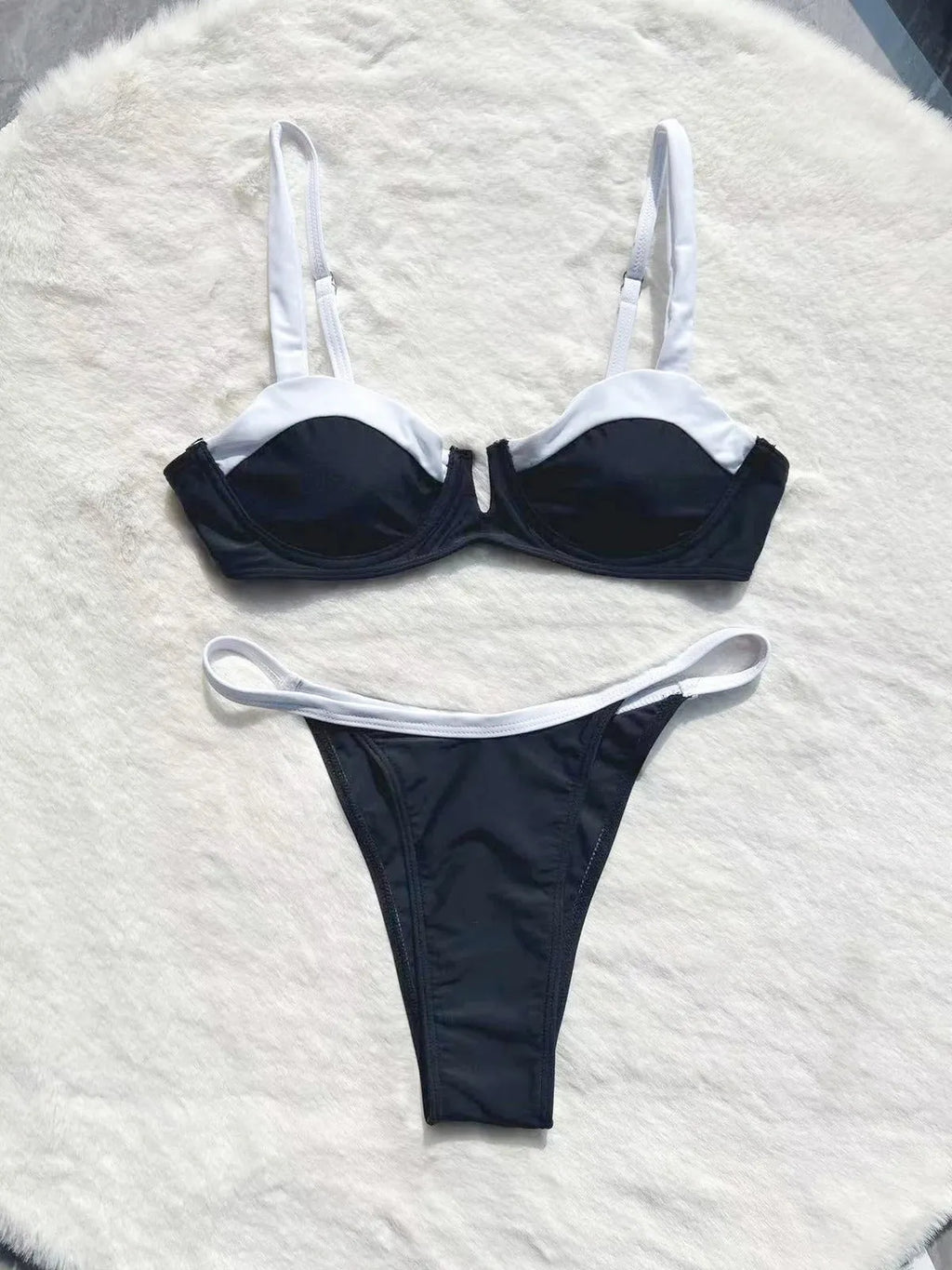 Black women's low waist bikini swimsuit with split stitching detail on the briefs.