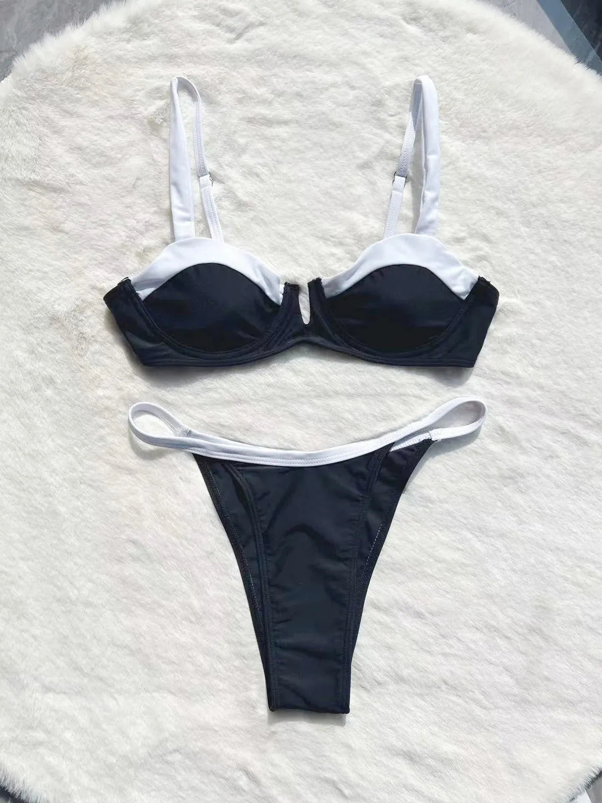 Black women's low waist bikini swimsuit with split stitching detail on the briefs.