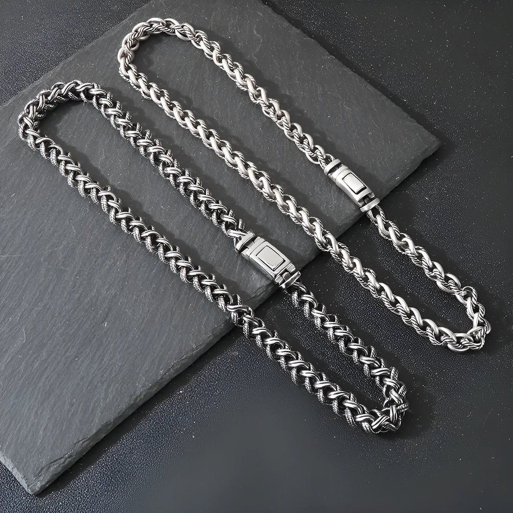 Men's antique silver titanium steel keel chain necklace with large hemp flower links on a grey background.
