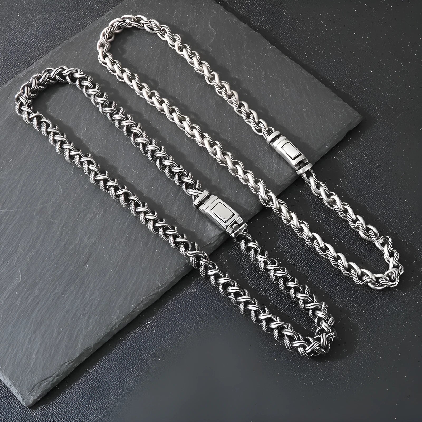 Men's antique silver titanium steel keel chain necklace with large hemp flower links on a grey background.