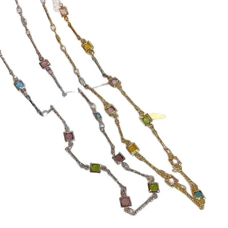 Square artificial crystal pendant on a fine gold clavicle chain necklace.