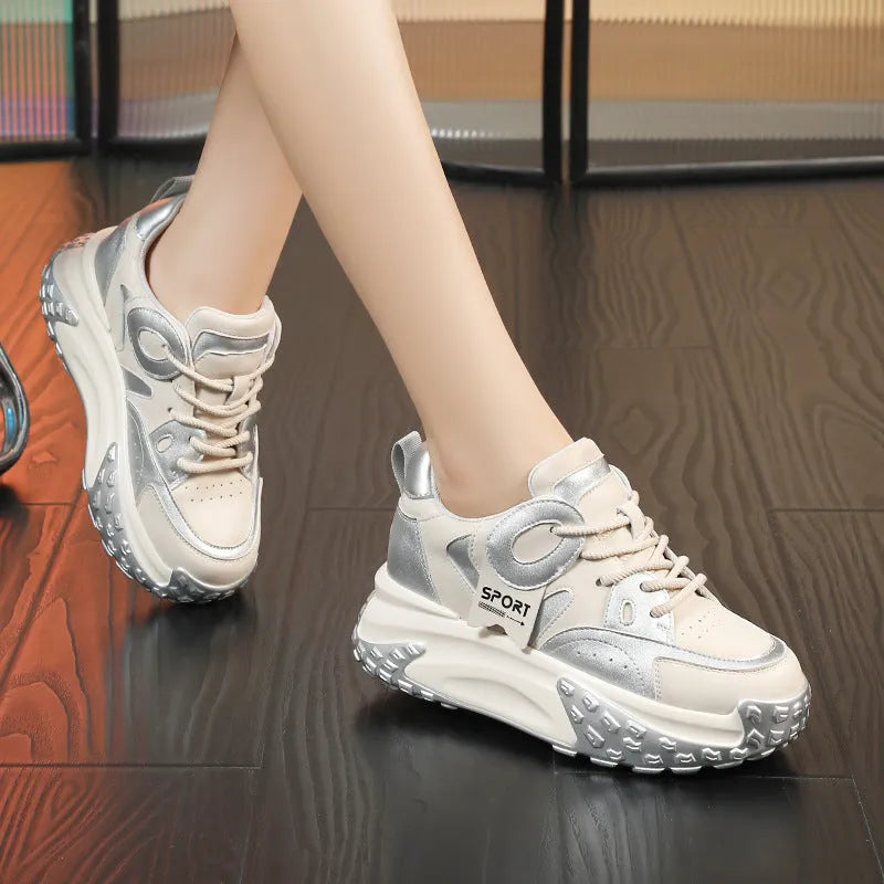 A pair of thick-soled leather casual shoes with a wedge heel and round toe in a lace-up design.